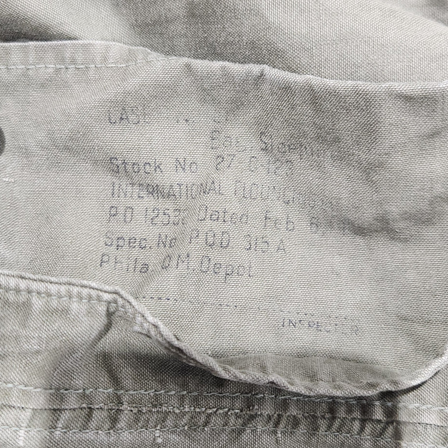 Close-up of a shirt with text on the collar