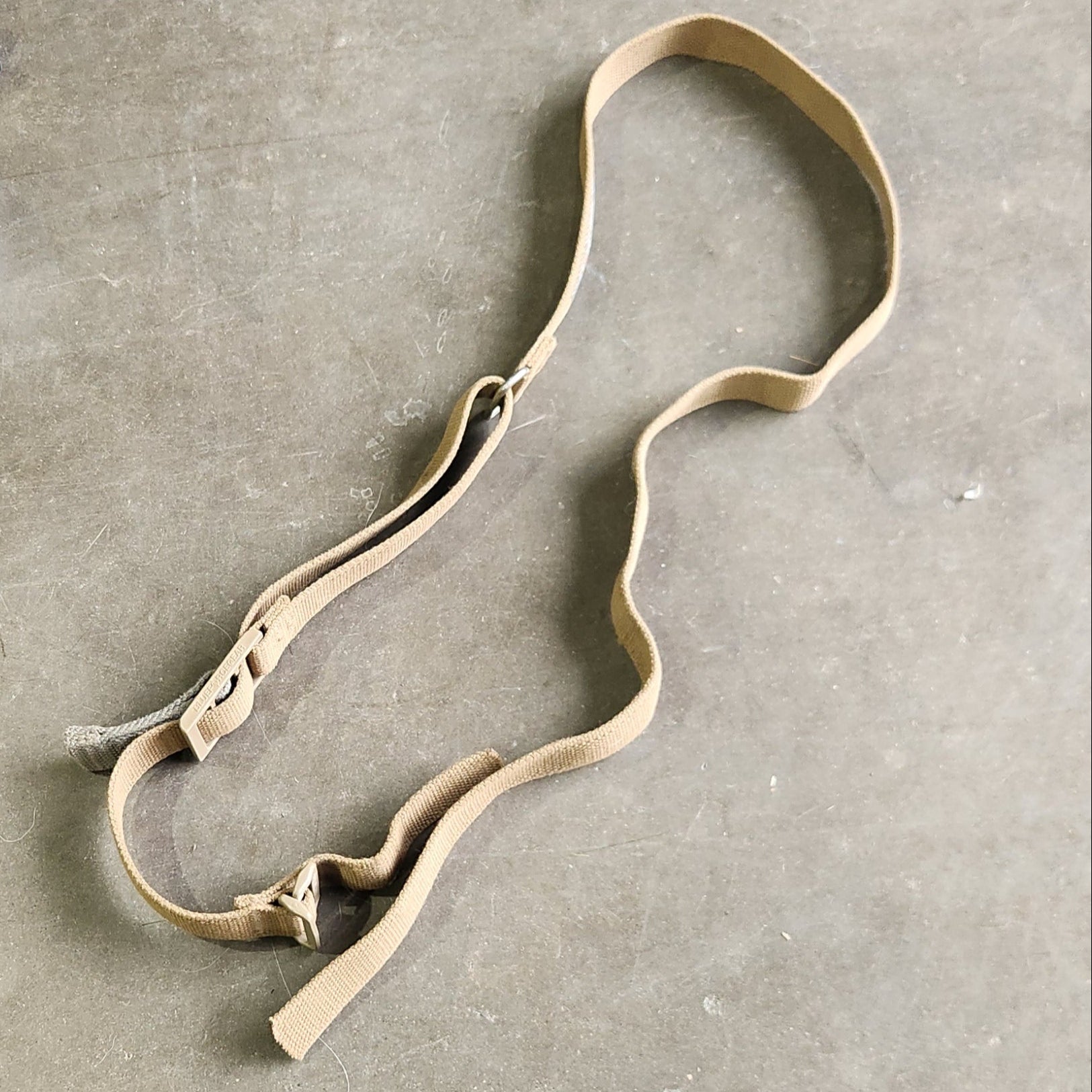 Bronze dog collar on a gray concrete floor