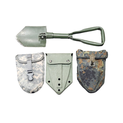 Set of military-style tools including a shovel and rakes on a concrete floor.