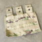 Multicam-patterned pouch with multiple straps on a concrete surface
