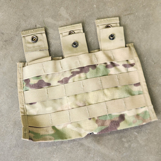 Multicam-patterned pouch with multiple straps on a concrete surface