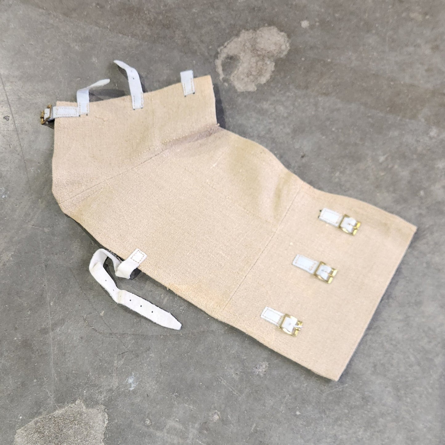 Beige chair seat cover on a concrete floor