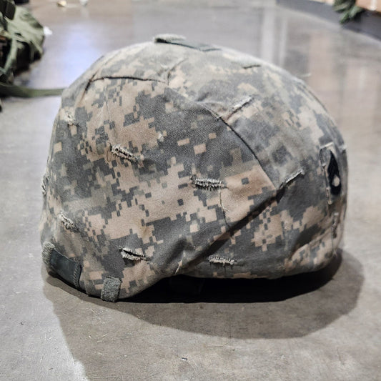 Camouflage helmet on a concrete floor
