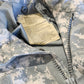 Close up of a camouflage uniform with a tag showing