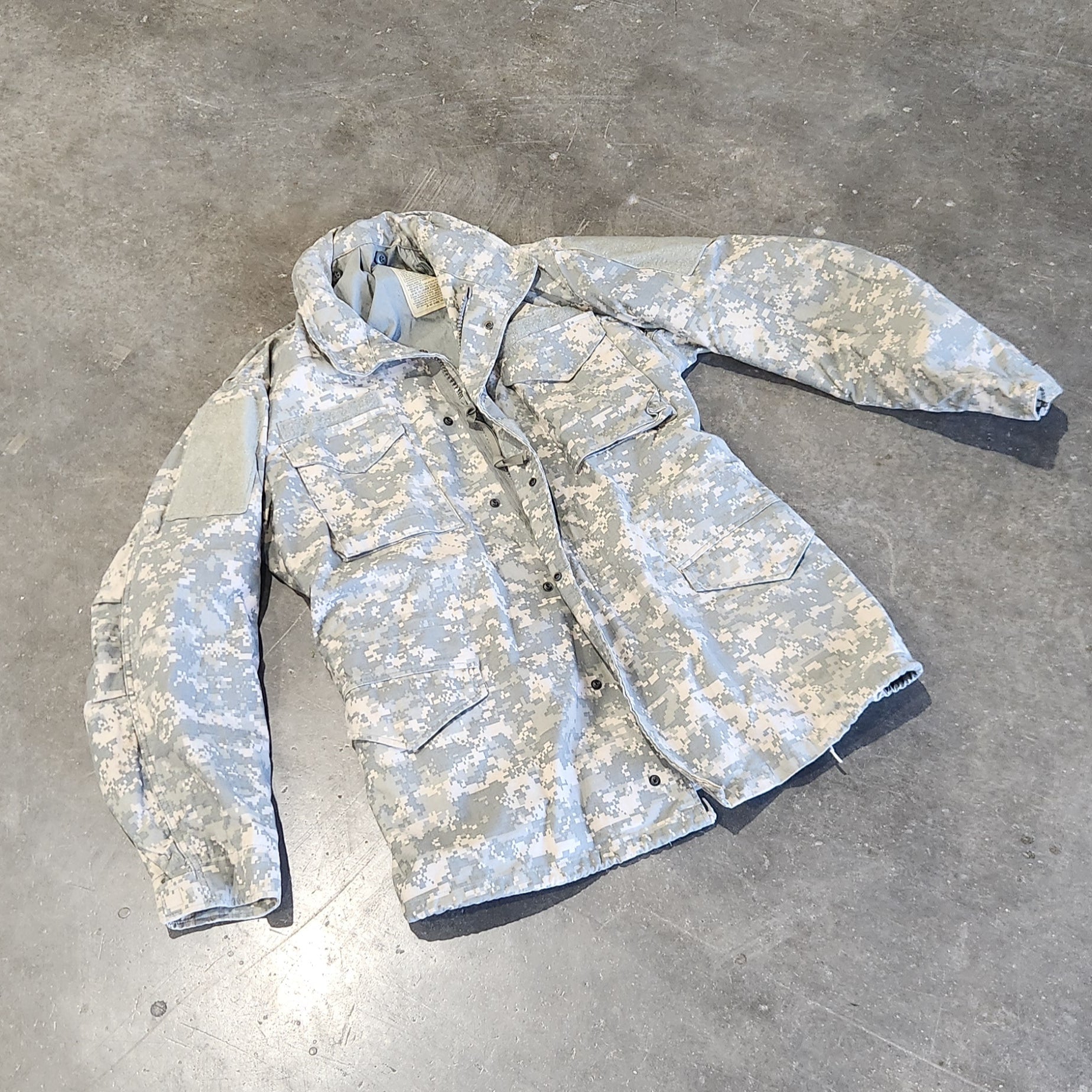 UCP M65 Jacket on a concrete floor