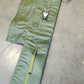 Green tool roll with a strap on a concrete floor
