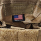 Close-up of a tactical pouch with American flag patch on a textured surface