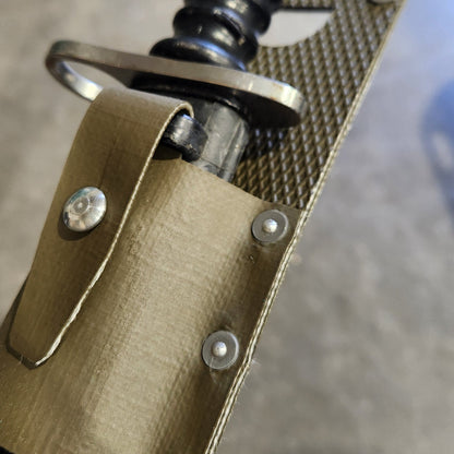 Close-up of a sword with a gold hilt and black blade on a metallic background