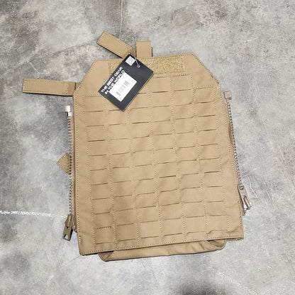 Tan tactical pouch on a concrete floor with a person's foot in the background