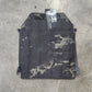 Camouflage pouch with a brand tag on a concrete floor