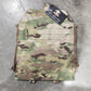 Multicam-patterned tactical plate carrier on a concrete floor