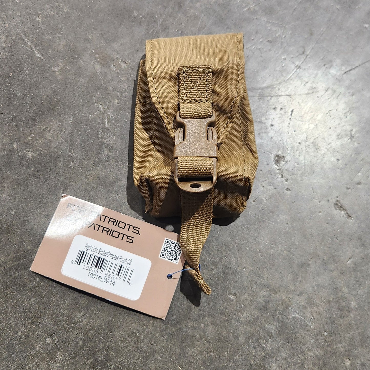 Brown tactical pouch on a gray surface with a visible brand label.