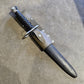  Dagger with sheath on a concrete floor