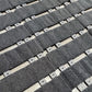 Grid of gray fabric straps with metal hardware on a beige background