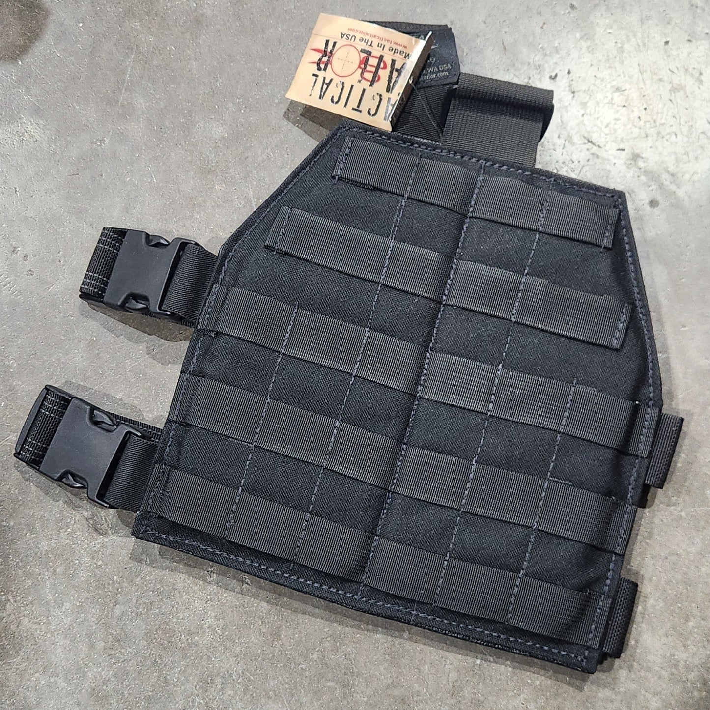 Black tactical leg panel on a concrete floor