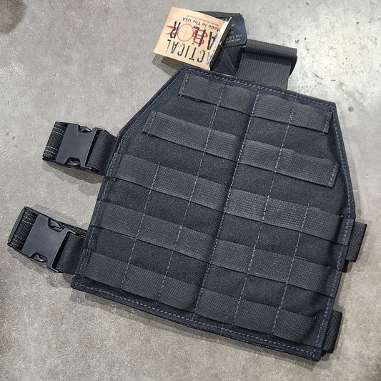 Black tactical leg panel on a concrete floor