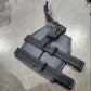 Black tactical pouch with straps on a concrete floor