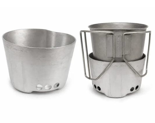 A silver aluminum camping pot shown in two views: disassembled on the left and assembled with its metal stand and handle on the right, set against a plain white background.