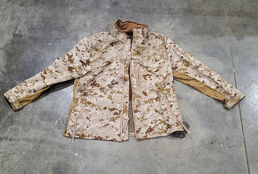 Camouflage jacket on a gray concrete floor